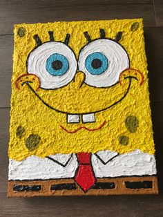 a spongebob cake with blue eyes and a red tie on it's face