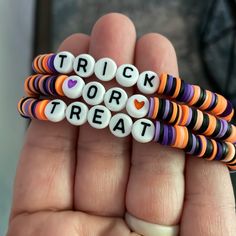 Set Of 3 Homemade Stretch Clay Bead Bracelets. Halloween Themed. A Great Addition To Your Halloween Attire. Purple, Orange And Black Colors That Say Trick Or Treat When Worn All Together. Halloween Bracelets For Kids, Clay Beads Bracelet Ideas For Halloween, Halloween Braclets Idea, College Clay Bead Bracelets, Fall Themed Beaded Bracelet, Clay Bead Bracelet Sets Ideas, Preppy Fall Bracelet Ideas, Halloween Glass Bead Bracelet, Preppy Halloween Clay Bead Bracelets