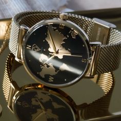 A beautiful and unique gold world map dial watch for all the wanderlust lovers. Would make a perfect gift for yourself or someone loved.  The travel watch features a black dial with embossed gold world map details and finished with an adjustable gold mesh strap. Her name "Alectrona" comes from the Roman mythology, who was the goddess of the sun. "Dare to live the life you've always wanted and create wonderful memories to cherish forever." ADDITIONAL INFORMATION: Movement - Japan movement  Materi Goddess Of The Sun, Map Watch, Gold World Map, World Map Design, Roman Mythology, Watches Unique, Women Wrist Watch, Globe Trotter, Wrist Watches