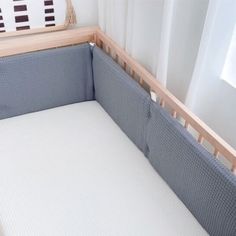 a baby crib with a white sheet on it