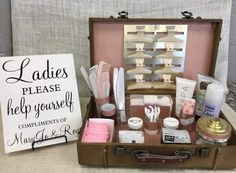 an open suitcase filled with personal care items and a sign that says ladies please help yourself