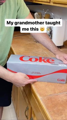 a man opening up a box that says'my grandmother taught me this coke '