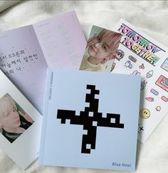 four books with pictures on them sitting on top of a white blanket next to each other