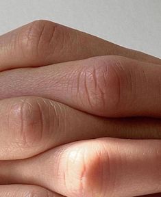 a person's hand with two rings on it