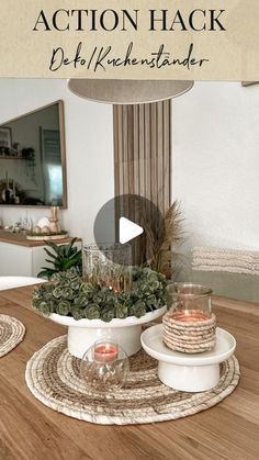 a table topped with plates and candles on top of a wooden table