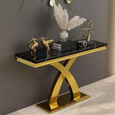 a black and gold console table with decorations on it