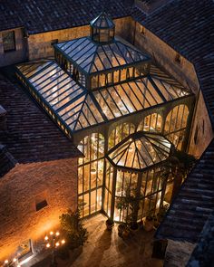 an aerial view of a glass house at night