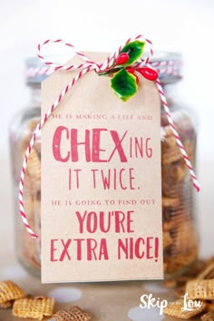 a jar filled with chex mix sitting on top of a table