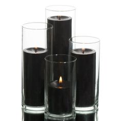 three glass vases with candles in them