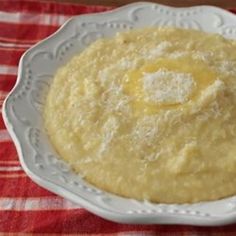 a white bowl filled with batter on top of a red and white checkered table cloth