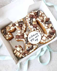 a box filled with cookies covered in chocolate and marshmallows on top of a table