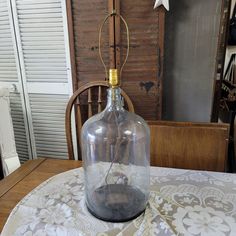 an empty glass bottle sitting on top of a table