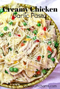 creamy chicken garlic pasta with peas in a bowl