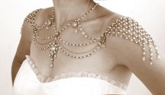 a woman in a white dress with pearls on her neck