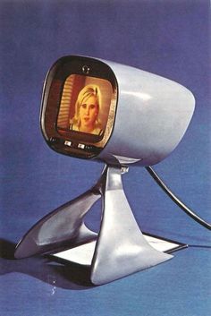 an old television with a woman's face on the screen