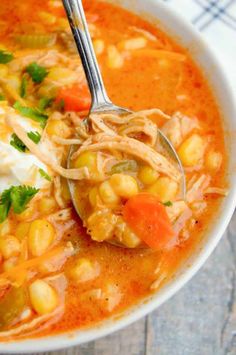 a white bowl filled with chicken and corn soup