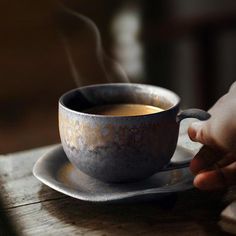 a cup of coffee with steam rising from it