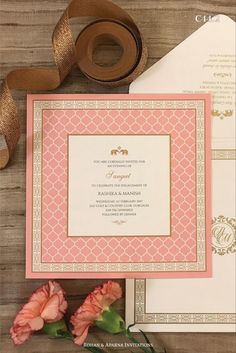 the wedding stationery is laid out with ribbon and flowers