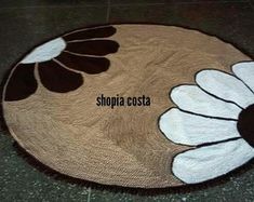 a brown and white rug with flowers on it that says shopia costa in the center