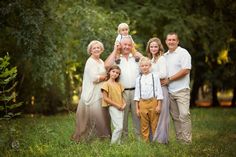 a family posing for a photo in the grass