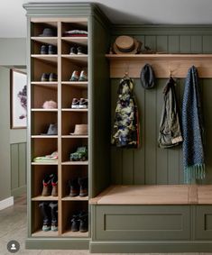 a wooden bench sitting next to a shelf filled with shoes and coats on top of it