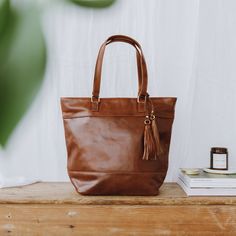 "The Harlow tote has a minimalistic style and is ideal as an everyday tote or work bag, as it will fit a 13\" laptop.   It holds its shape well and closes with a zip, so you can be confident that your belongings are safe. Bag Features - one main inside compartment - two internal slip pockets  - small internal zipped pocket - bag closes with a zip - fully lined in a floral print fabric  - finished with nickel-free brass hardware Bag Dimensions inches:  H13 x W16 (at the widest point) x D6 x Handl Laptop Bag With Detachable Handle For Everyday Use, Leather Weekender Bag With Detachable Handle For Everyday, Soft Leather Tote Laptop Bag, Rectangular Weekender Bag With Detachable Handle, Daily Use Laptop Bag With Detachable Handle Tote, Elegant Tote Weekender Bag For Daily Use, Elegant Brown Weekender Bag For Everyday Use, Everyday Tote Bag With Handle Drop, Elegant Soft Leather Weekender Bag For Everyday Use