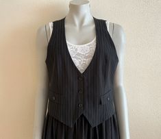 "Women's Vest Black Striped Vest Black Womens Waistcoat Steampunk Formal Fitted Victorian Renaissance Baroque Edwardian Medium Size Label size: 38/40 EUR,12 UK Measurements (lying flat): Length(back): 19.5\"/ 49.5 cm Pit to pit: 19\"/ 48 cm Waist: 17.5\"/ 44.5 cm Please check measurements to insure a proper fit. Remember to allow yourself some extra room for movement. You can compare these with something from your closet that fits you well. Condition: great Vintage Condition Material: polyester, Punk Style Fitted Vest For Fall, Fitted Black Vest For Costume, Black Fitted Vest For Alternative Fashion, Fitted Black Vest For Alternative Fashion, Black Gothic Vest For Fall, Black Fitted Steampunk Vest, Fitted Gothic Vest For Winter, Fitted Vest For Spring Alternative Fashion, Fitted Steampunk Vest For Fall