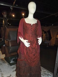 a mannequin wearing a red dress in a store