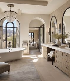 a large bathroom with an arched window and tub in the center, along with double sinks