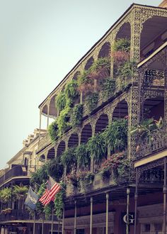 an old building with plants growing on the balconies