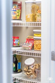 an open refrigerator door with food and drinks on shelves next to each other in it