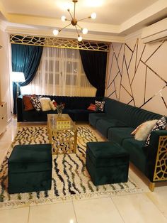 a living room filled with green couches next to a white rug on top of a hard wood floor