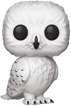 a white owl figurine sitting on top of a table