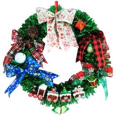 a christmas wreath with ornaments hanging from it's sides and bows on the front