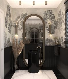 a bathroom with black and white wallpaper, gold accents and a large mirror over the sink