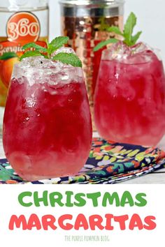 two glasses filled with christmas margaritas sitting on top of a table