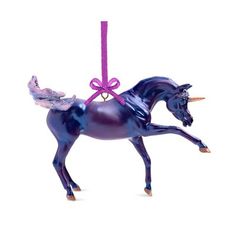 a purple christmas ornament with a horse on it's hind legs and tail