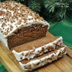 a loaf of carrot cake sitting on top of a wooden cutting board