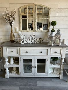 a white painted buffet table with glass doors