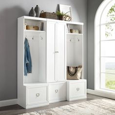 a white cabinet with drawers and baskets on it