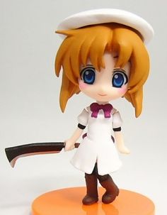 an anime figurine is posed on a white surface