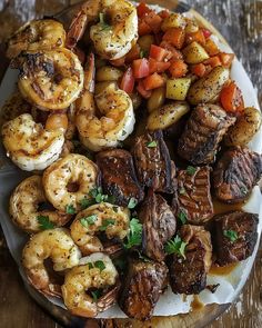 a plate full of shrimp, potatoes and carrots