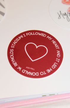 a red sticker with a heart on it