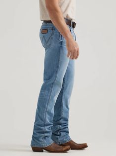 NOTHING BEATS AN ORIGINAL, BUT THIS MIGHT Since 1947, Wrangler® jeans have been a cowboy-approved wardrobe staple. Inspired by our Western heritage, these Wrangler® Retro® jeans combine our most iconic features with contemporary fits and washes. This updated classic features the same worn leather patch with our rope logo, 'W' stitching on the back pockets, and five-pocket styling. These men's slim bootcut jeans feature a streamlined silhouette through the seat, thigh, and knee, but the leg widens from the knee downward, which is good news for boots. When it comes to finding the best bootcut jeans for men, your search ends here. Shop from a wide variety of sizes and washes to find the perfect addition to your everyday ensemble. Style: 112346916 99% Cotton/ 1% SpandexFit: Slim Rise: Low Fron Men Workwear, Gentlemen Style, Mens Bootcut Jeans, Retro Jeans, Cowboy Outfits, Bootcut Jean