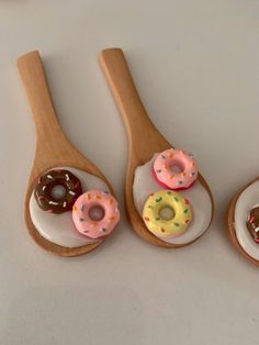 three wooden spoons with donuts on them