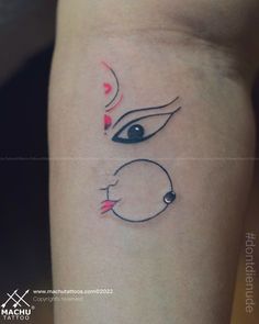 a woman's arm with an eye tattoo on the left side of her body