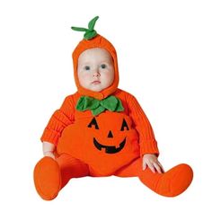 a baby dressed in an orange pumpkin costume