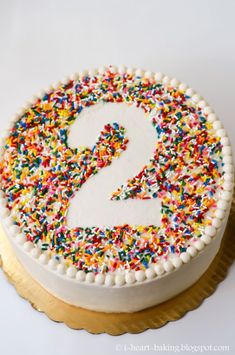 a birthday cake with sprinkles and the number nine on it's side