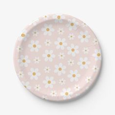 a pink paper plate with white and yellow daisies on the rim, against a white background