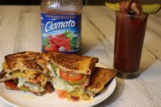 a sandwich cut in half sitting on top of a white plate next to a drink